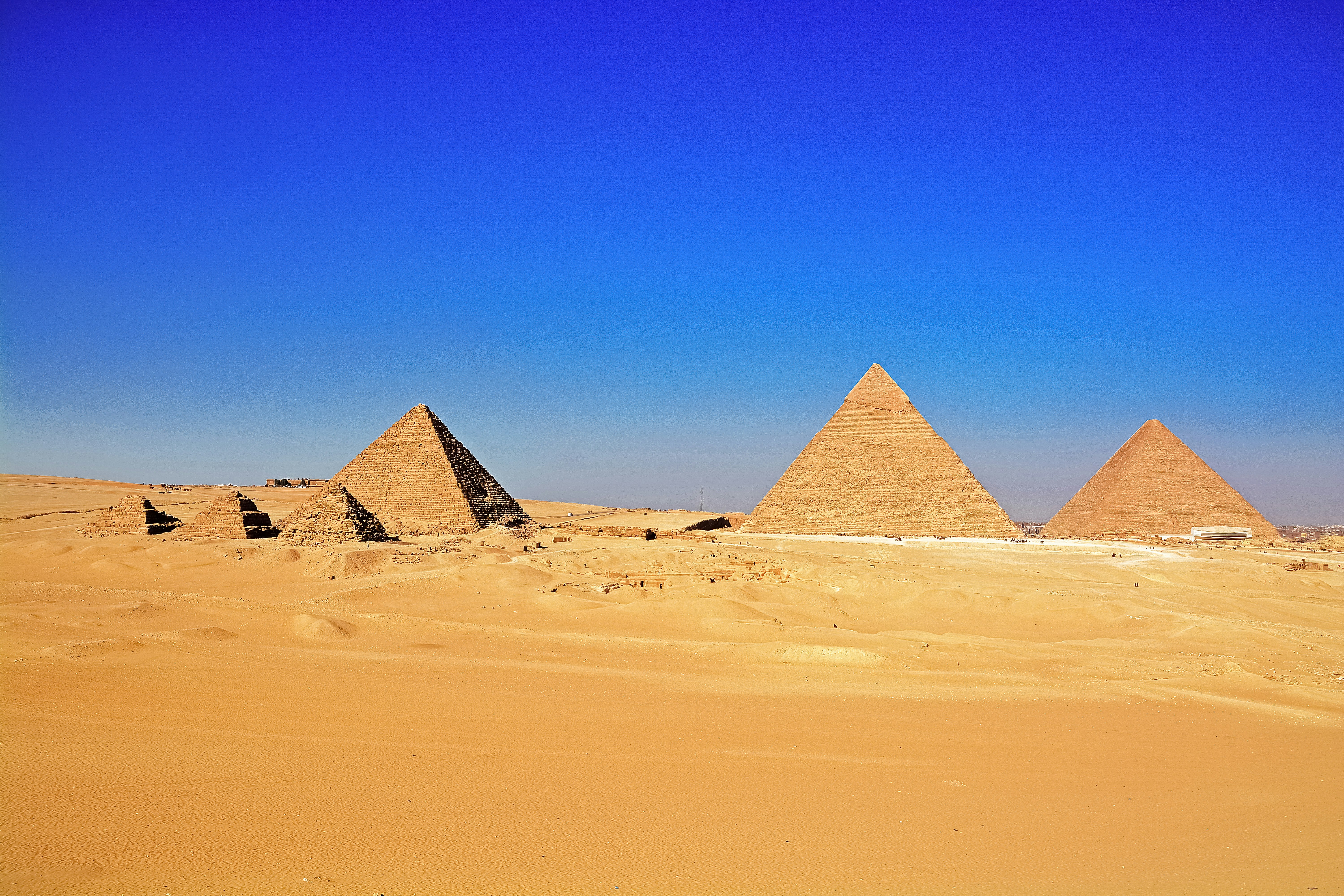 brown pyramid on desert under blue sky during daytime